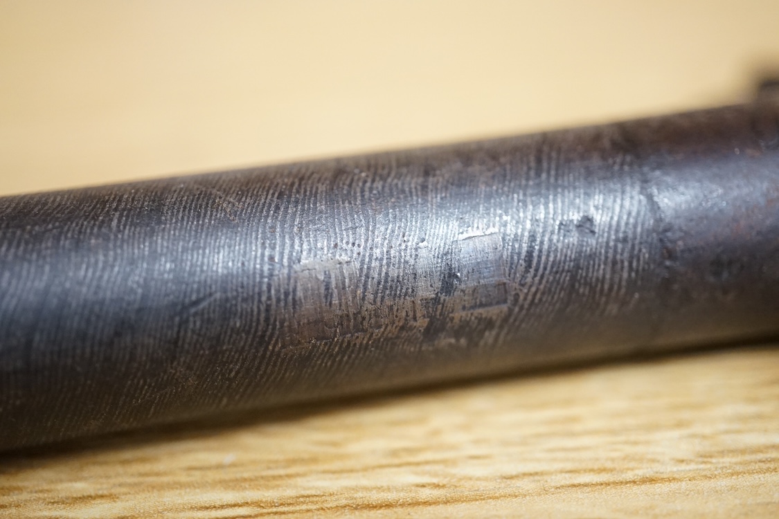 A boxlock percussion pocket pistol with turn off barrel etched with ribbon twist, engraved rounded frame, liege proved, with rounded walnut butt
